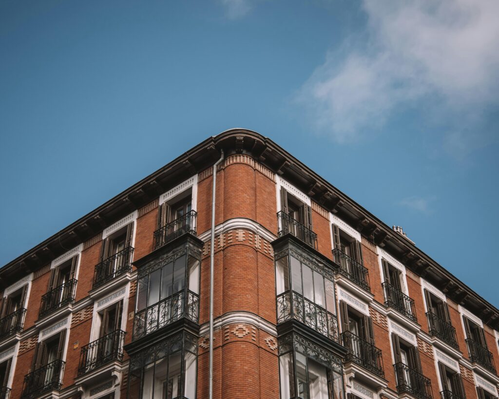 Architectural facade of a historic red brick building in Madrid, Spain.